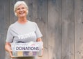 Smiling female volunteer holding donations box