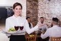 Smiling female waitress carrying order for guest Royalty Free Stock Photo