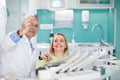 Smiling female woman with dentist looking at dental snapshot