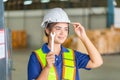 Smiling female worker in hardhat and holding wrench, Woman working in manufacturing Royalty Free Stock Photo