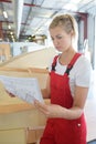 smiling female worker holding clipboard in warehouse Royalty Free Stock Photo