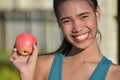 Smiling Filipina Female With Apple