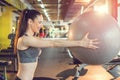 Side view of fitness woman with ponytail doing exercise with pilates ball in gym. Royalty Free Stock Photo