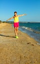 Smiling fit woman on beach in evening having fun time Royalty Free Stock Photo