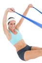 Smiling fit woman exercising with a blue yoga belt Royalty Free Stock Photo