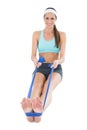 Smiling fit woman exercising with a blue yoga belt Royalty Free Stock Photo