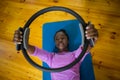 Smiling fit woman exercising with pilates ring on mat Royalty Free Stock Photo