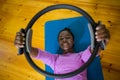 Smiling fit woman exercising with pilates ring on mat Royalty Free Stock Photo