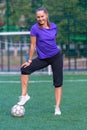 Smiling fit woman posing with a soccer ball Royalty Free Stock Photo