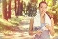 Smiling fit woman with white towel resting after sport exercises