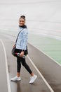 Smiling fit young african sportswoman carrying sportsbag Royalty Free Stock Photo