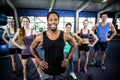 Smiling fitness class posing together with hands on hips Royalty Free Stock Photo