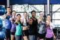 Smiling fitness class posing together with thumbs up Royalty Free Stock Photo