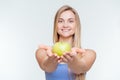 Smiling fitness woman giving apple at camera Royalty Free Stock Photo