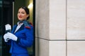 A smiling flight attendant holds a passport and a boarding pass.Copy the writing space on the left