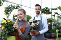 Smiling Florist Holding Blooming Flowers in Pot Royalty Free Stock Photo