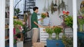 Smiling florist sell flowers to african buyer in floristry store. Floral concept Royalty Free Stock Photo