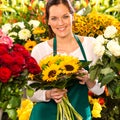 Smiling florist woman bouquet sunflowers flower shop