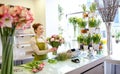 Smiling florist woman making bunch at flower shop Royalty Free Stock Photo