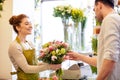 Smiling florist woman and man at flower shop Royalty Free Stock Photo