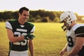 Smiling football teammates talking after a late afternoon practi Royalty Free Stock Photo