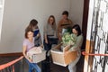 Smiling, foretaste students carrying luggage and stuff on the stairs joke and talk together. Independence for first year