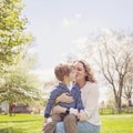 Happy Grandmother kissing grandson in park Royalty Free Stock Photo