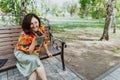 Smiling freelancer woman animatedly chatting on smartphone outdoor