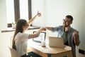 Smiling freelancers giving fists bump and showing thumbs up Royalty Free Stock Photo