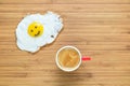 Smiling fried egg lying on a wooden cutting board with small red cup of coffee near it. Classic Breakfast concept. Royalty Free Stock Photo