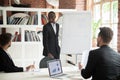 Smiling friendly african coach giving presentation to businessme Royalty Free Stock Photo