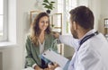 Smiling friendly doctor giving consultation a woman during medical examination in clinic. Royalty Free Stock Photo