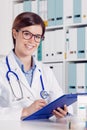Smiling friendly doctor writing notes Royalty Free Stock Photo