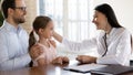 Smiling friendly pediatrician stroking little patient head at meeting