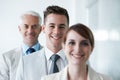 Smiling , friendly group of three businesspeople , and of different age private company staff posing for office portrait Royalty Free Stock Photo