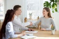 Smiling friendly hr manager handshaking applicant welcoming at job interview