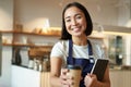 Smiling friendly waitress in coffee shop, barista giving out takeaway order, cappuccino in paper cup for takeout