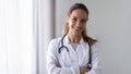 Smiling friendly young female professional confident doctor head shot. Royalty Free Stock Photo