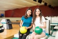 Smiling Friends With Bowling Balls In Club Royalty Free Stock Photo