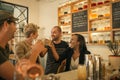 Smiling friends cheering with drinks in a trendy bar Royalty Free Stock Photo