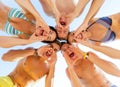 Smiling friends in circle on summer beach Royalty Free Stock Photo