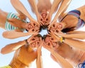 Smiling friends in circle on summer beach Royalty Free Stock Photo