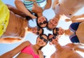 Smiling friends in circle on summer beach Royalty Free Stock Photo