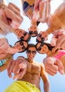 Smiling friends in circle on summer beach Royalty Free Stock Photo