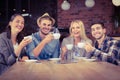 Smiling friends enjoying coffee together Royalty Free Stock Photo