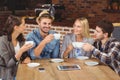 Smiling friends enjoying coffee together Royalty Free Stock Photo