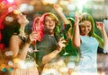 Smiling friends with glasses of champagne in club Royalty Free Stock Photo