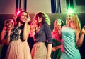 Smiling friends with glasses of champagne in club Royalty Free Stock Photo