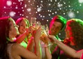 Smiling friends with glasses of champagne in club Royalty Free Stock Photo