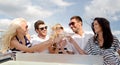 Smiling friends with glasses of champagne on yacht Royalty Free Stock Photo